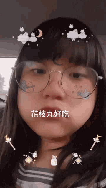 a girl wearing glasses and a striped shirt has chinese characters on her face