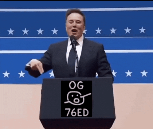 a man in a suit and tie is giving a speech at a podium that says og 76ed on it