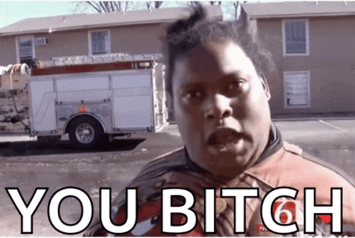 a man standing in front of a fire truck with the words you bitch written on his face