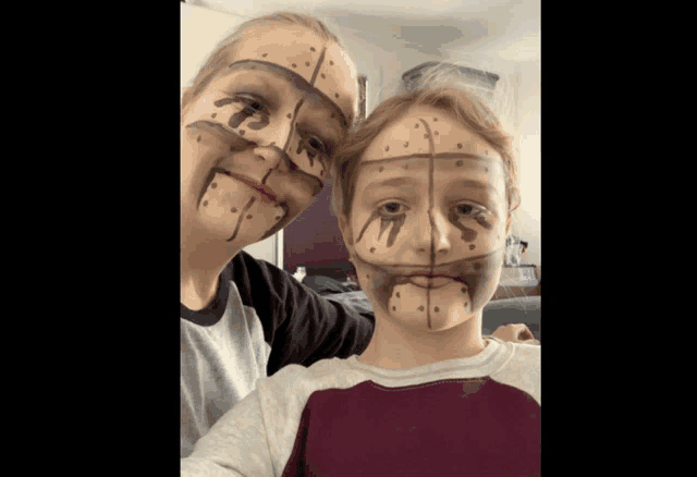 a woman and a boy with their faces painted