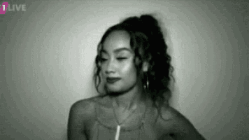 a black and white photo of a woman with her eyes closed and her hair in a ponytail .