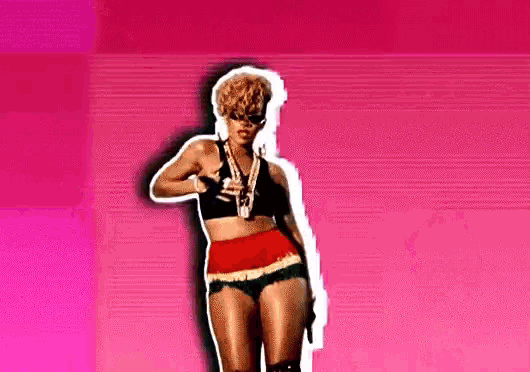 a woman in a crop top and shorts is pointing at something