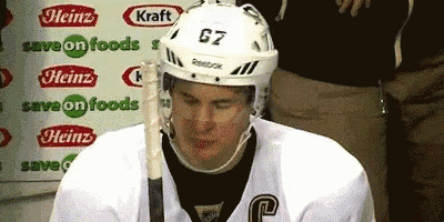 a hockey player wearing a white helmet with the number gz on it