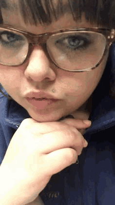 a close up of a woman wearing glasses and a blue jacket that says ohio