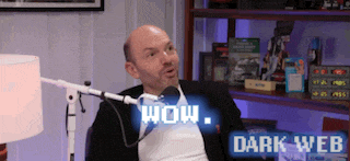 a man is sitting in front of a microphone with the words wow dark web behind him