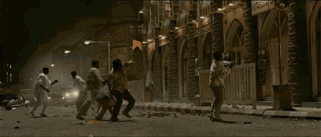a group of people are fighting in front of a building that says ' eastern bank ' on it