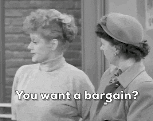 two women are standing next to each other and talking to each other .