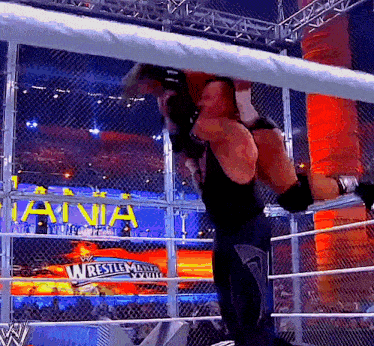 a wrestlemania sign is behind a fence