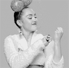 a black and white photo of a woman wearing a minnie mouse headband giving the middle finger