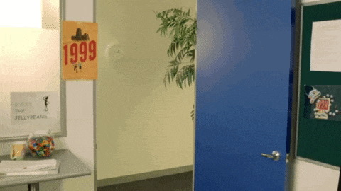 a blue door is open to a room with a sign on the wall that says 1999