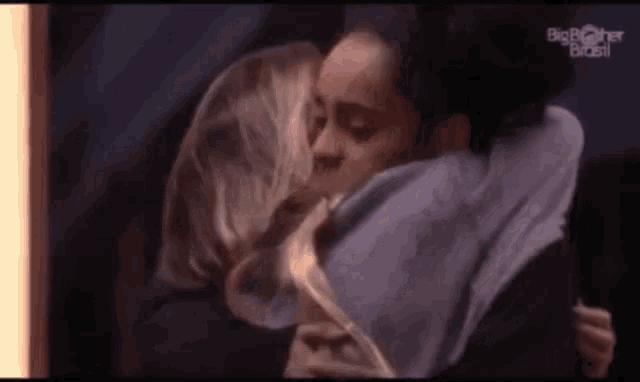a couple of women are hugging each other in a room .
