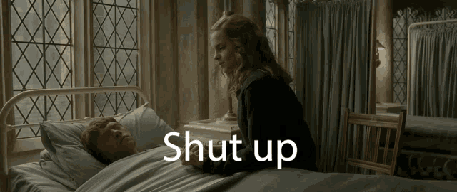 a woman stands next to a man laying in a hospital bed with the words shut up written on the bottom