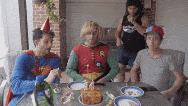 a group of men are celebrating a 14th birthday with a cake