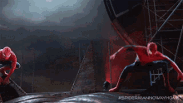 a group of spider-men are fighting each other in a dark room .