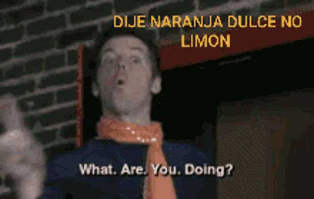 a man wearing an orange scarf says what are you doing in spanish