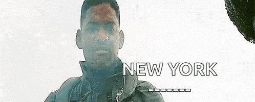 a man is standing in front of a white background with the words `` new york '' on it .