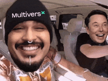 a man wearing a beanie that says multivers x smiles next to elon musk