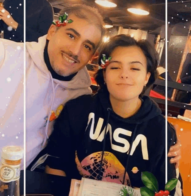 a man and a woman are posing for a picture and the man is wearing a nasa hoodie