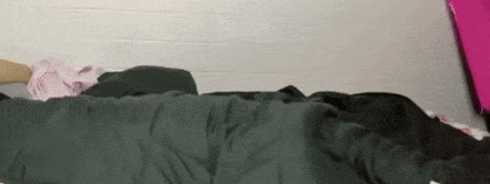 a person is laying on a bed with a blanket on .