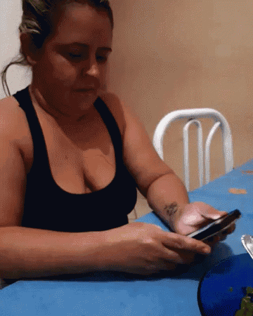 a woman with a tattoo on her arm is using a cell phone