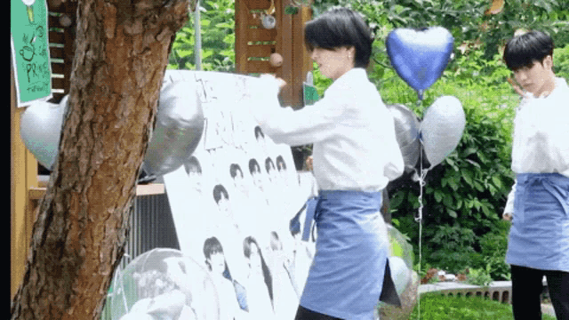 a man in an apron is standing next to a sign that says ' prince '