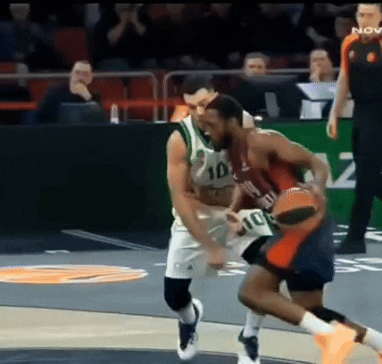 a basketball player wearing a number 10 jersey tries to block another player