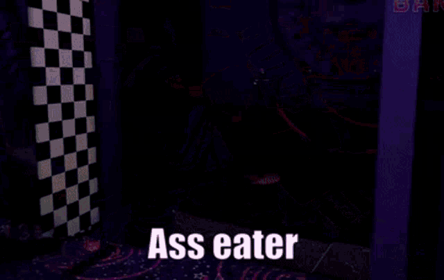 a close up of a robot 's butt with the words ass eater written on it