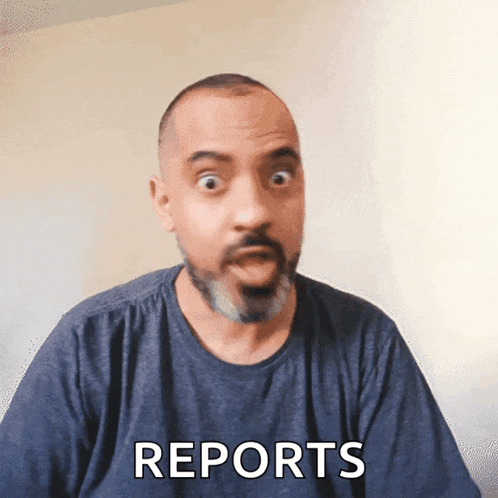 a man with a beard is wearing a blue shirt and says reports