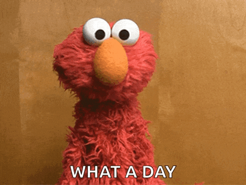 elmo from sesame street says " what a day " in front of him