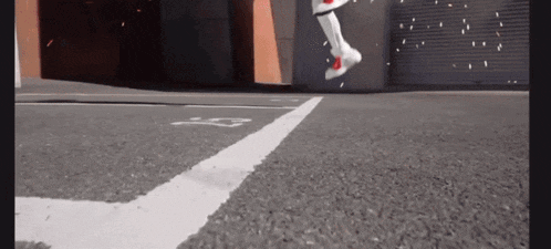 a person is jumping in the air while wearing a pair of white sneakers .