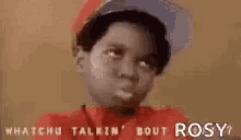 a young boy wearing a hat and a red shirt is talking to rosy .