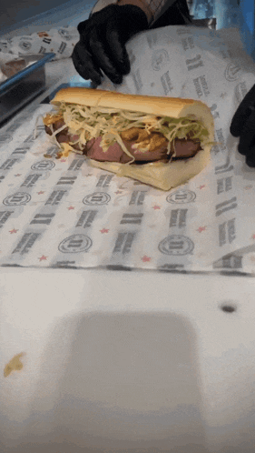 a sub sandwich is wrapped in a piece of paper that says ' america '