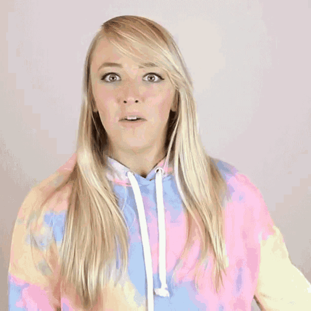 a woman says what the heck in front of a colorful background