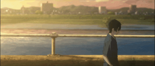 a man is walking along a railing near a body of water