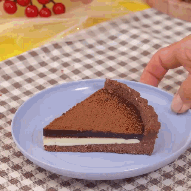a person is taking a slice of chocolate pie from a blue plate