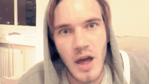 a close up of a man wearing a hooded sweatshirt making a funny face .