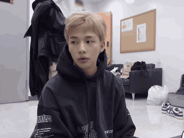 a young man wearing a hoodie that says hunters