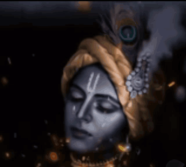 a close up of a person wearing a turban with a peacock feather on it .