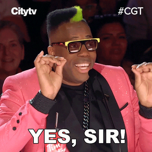 a man in a pink suit says yes sir in front of a crowd