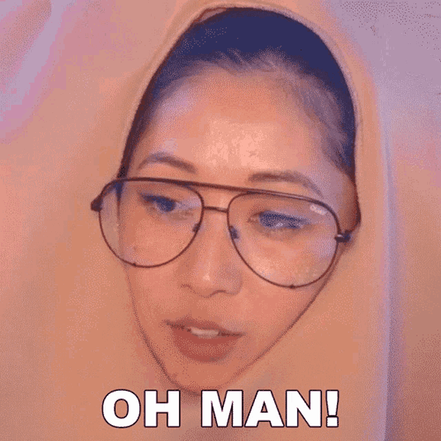 a woman wearing glasses and a hooded jacket says oh man