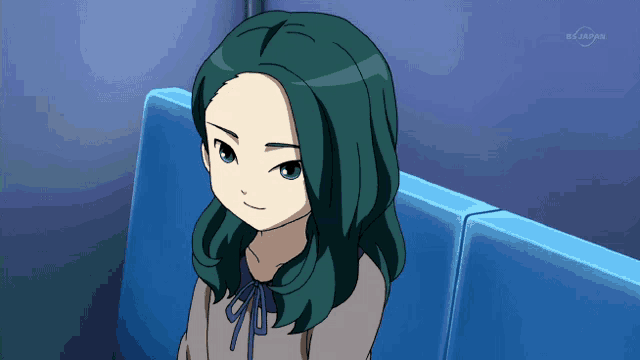 a girl with green hair is sitting on a blue couch in front of a tv screen that says tv tokyo