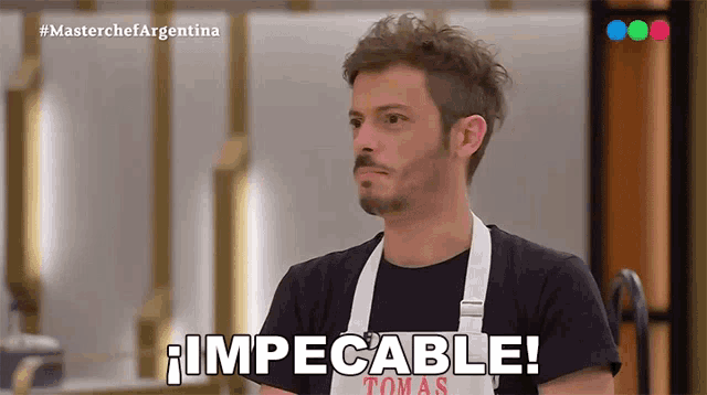 a man wearing an apron that says impecable