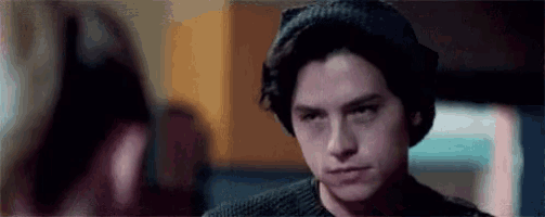 a close up of a man wearing a beanie and a sweater .