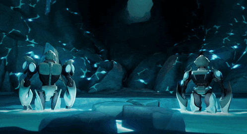 two robots are standing in a cave surrounded by rocks and water