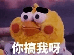a stuffed chicken with big eyes is sitting on a bed and making a funny face .