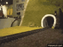 a gif of a train going through a tunnel is on makeagif.com