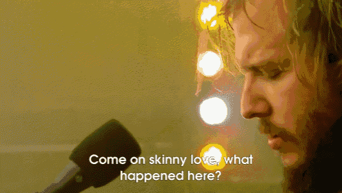 a man singing into a microphone with the words " come on skinny love what happened here "