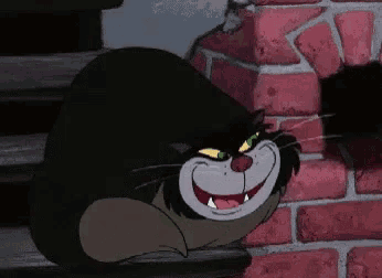 a cartoon cat with green eyes is laying on a set of stairs .