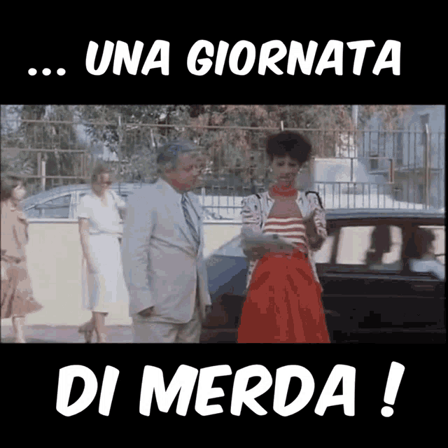 a man in a suit and tie stands next to a woman in a red dress and the words una giornata di merda !