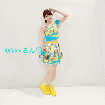 a woman in a blue and yellow dress stands next to another woman wearing a blue and yellow dress